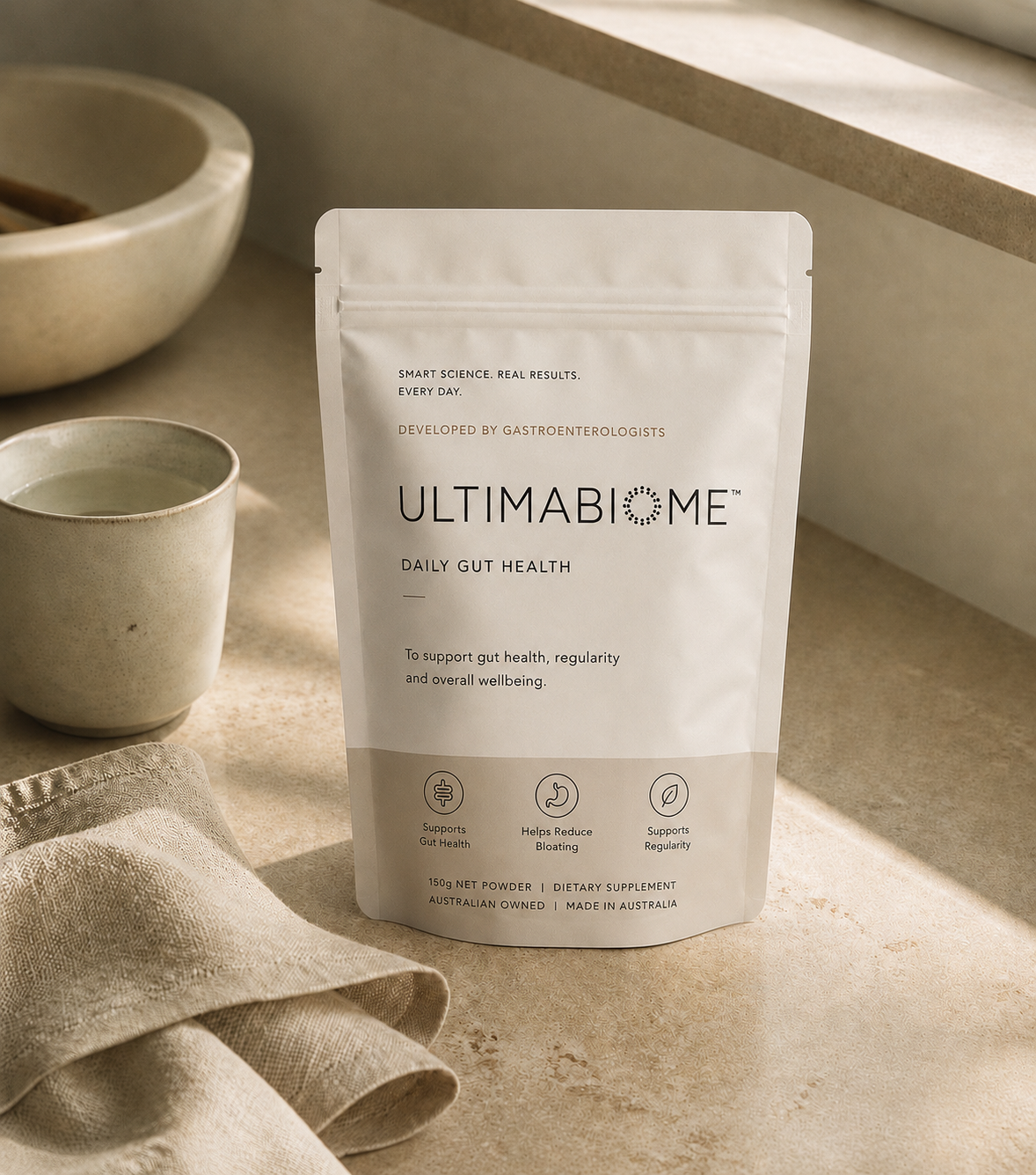 ULTIMABIOME pouch on a warm stone countertop